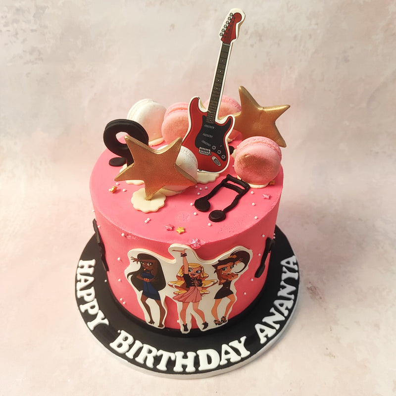 With whimsical buttercream music notes, this Girl Group Cake features a charming guitar, surrounded by pink and white macarons, and sprinkled with edible gold stars.