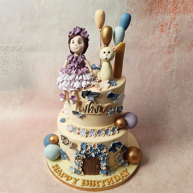 Blue, purple, and gold baubles and balloons, along with delicate blue and white edible butterflies, dance around this Princess Cat Cake.