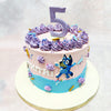 Here's a Purple Bluey Cake that captures the whimsical world of Bluey, featuring delicate purple buttercream swirls and playful design elements. 