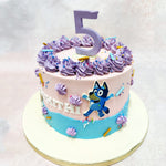 Here's a Purple Bluey Cake that captures the whimsical world of Bluey, featuring delicate purple buttercream swirls and playful design elements. 