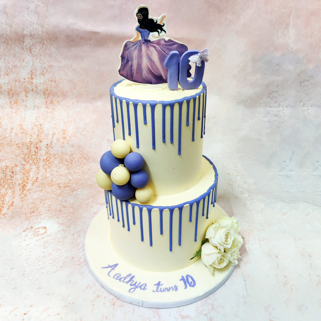 This enchanting two-tier Purple Princess Cake captures the essence of fairytale elegance with its stunning princess-themed design. 