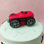 The vibrant red colour of the red car cake topper represents passion and excitement, while the light blue base symbolises tranquillity and harmony.