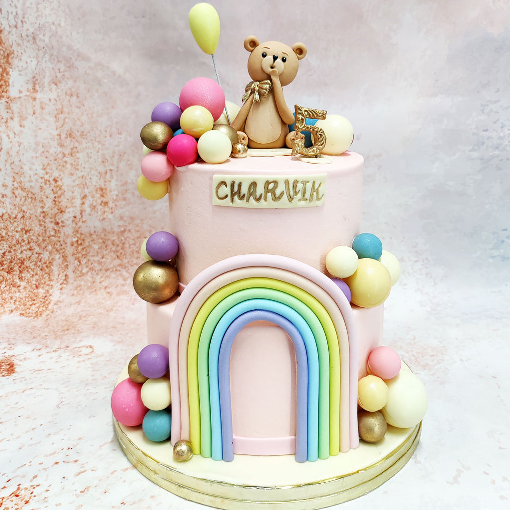 This charming Rainbow Teddy Bear Cake is the perfect combination of playful details and soft pastels, making it an ideal choice for a child’s special celebration. 