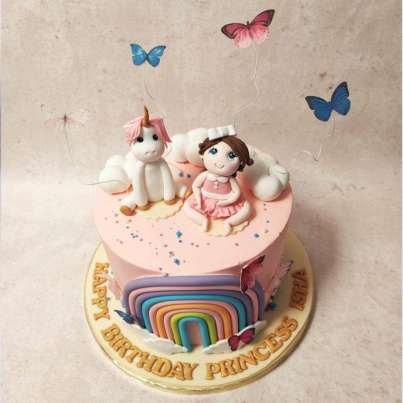 The pink colour palette adds a touch of femininity to this rainbow unicorn cake, enhancing the overall aesthetic appeal.