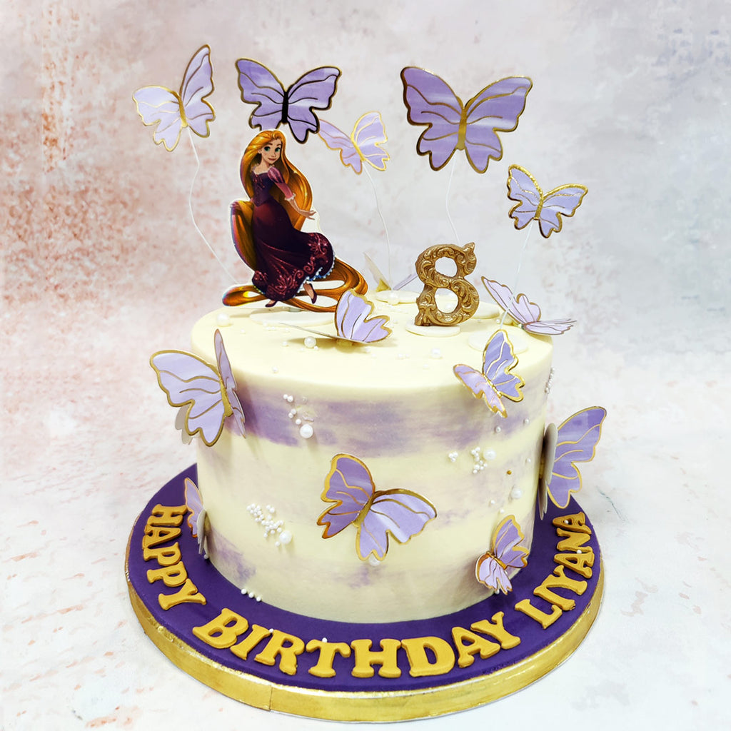 Dancing across this Rapunzel Theme Cake With Butterflies are elegant butterflies in various sizes, each detailed with shimmering golden edges that catch the light like lanterns in the night sky. 