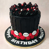 The red and white accents are complemented further by the ornamentation at the bottom of this chocolate skull cake with edible skulls that can be spotted between red buttercream roses. 