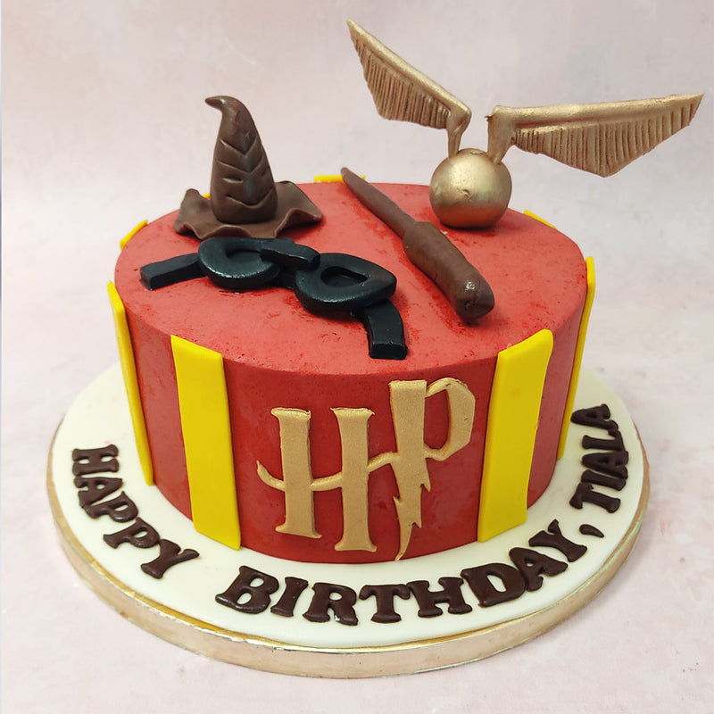 This Gryffindor Harry Potter cake is beautifully decorated with edible figurines that pay homage to some of the most beloved symbols from the series.