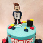 The bottom layer of this gamer cake is adorned with grey brick-like patterns, reminiscent of the building blocks that players use to construct their virtual worlds. 