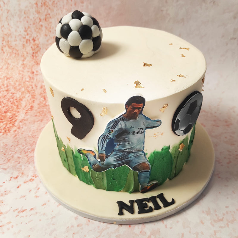 As the focal point, a 2D edible printout captures Ronaldo in action, showcasing his iconic kick with unparalleled finesse on this Ronaldo Football Cake. 