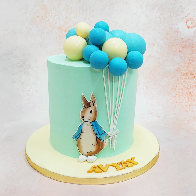 With a gentle grasp on a string of blue and white balloons, fashioned from delectable chocolate, Peter Rabbit leads the way into a world of imagination and delight through our Simple Rabbit Cake.