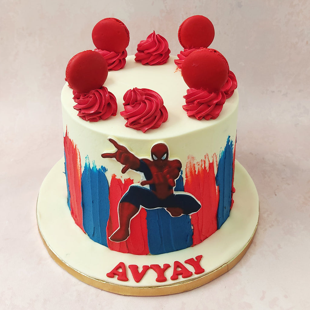 Featuring an artistic spread of the famous red and blue tones associated with Spiderman at the bottom of this Spiderman birthday cake for kids, this piece utilises this famous colour palette throughout its ornamentation.