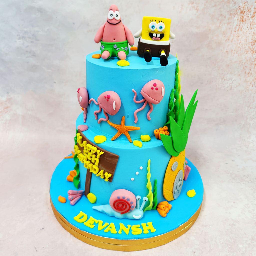 This quirky SpongeBob Patrick Cake brings an ocean of laughter to your celebration. Set against a bright aquatic blue, this double-tiered treat captures the spirit of Bikini Bottom in delicious detail. 