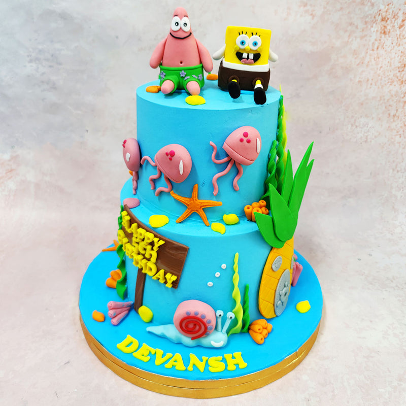 This quirky SpongeBob Patrick Cake brings an ocean of laughter to your celebration. Set against a bright aquatic blue, this double-tiered treat captures the spirit of Bikini Bottom in delicious detail. 