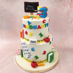With its white base and a yellow ruler elegantly wrapped around the bottom tiers, this teacher’s cake immediately evokes memories of classrooms and learning.