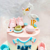 Tiny booties, scattered flowers, and delicate textures bring out the sweetness of this Stork Cake, where the iconic white stork proudly carries a bottle, announcing the arrival of a little one in its own whimsical way. 