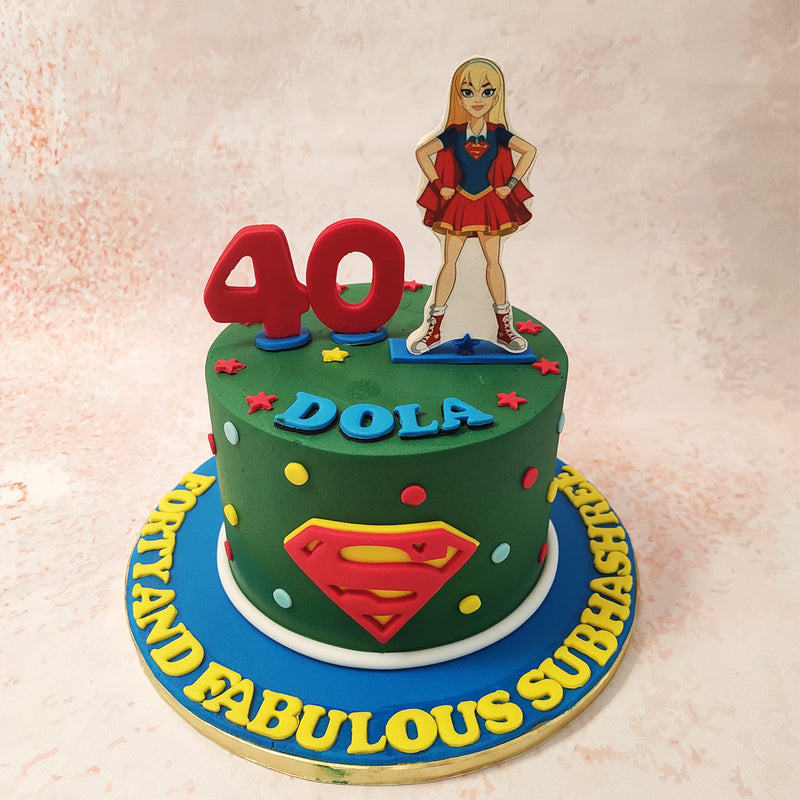 At the heart of this Supergirl Cake, the iconic Superwoman logo gleams with pride, a symbol of resilience and determination. 