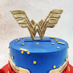 This Wonder Woman Theme Cake cleverly incorporates the iconic elements of Wonder Woman's costume, with a deep royal blue upper tier adorned with scattered golden stars that shimmer like the night sky.