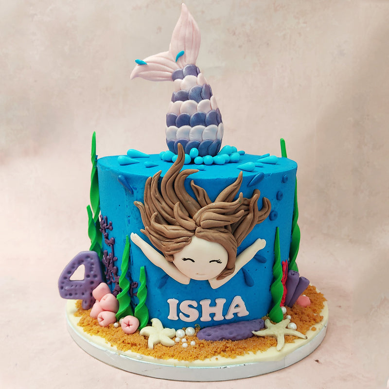 The base of our swimming mermaid cake is a beautiful shade of blue, representing the vast ocean that the mermaid calls home.