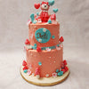 For the little princess in your life, this would be the perfect birthday cake for her as it is beautifully decorated with an array of colorful flowers, mushrooms, and balloons, adding an extra touch of magic to the design. 