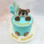 Adding to the allure of this Teddy Theme Cake With Lollipops are the balloon-shaped decorations rising behind the bear, each delicately adorned with golden accents.