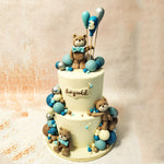 As you gaze upon the smooth white tiers of this Teddy Balloon Cake, adorned with the sweetest brown teddy bears sporting dashing blue bow ties, you'll feel the joy of childhood come to life.