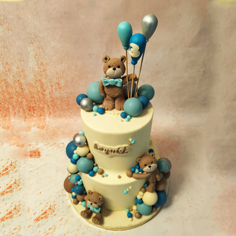 Meanwhile, the tiers of this Teddy Theme Cake are bedecked with a delightful array of chocolate spheres resembling balloons. 