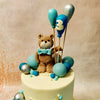 Picture this: one adorable teddy bear perched atop the bottom tier of this Teddy Bear and Balloon Cake, inviting you to join the festivities. 