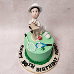 Perched atop this badminton cake is the star player, a figurine crafted with meticulous detail. Clad in his sporty attire, he stands poised and ready on this badminton cake, bat and ball in hand, as if caught in a frozen moment of anticipation before the decisive hit. 