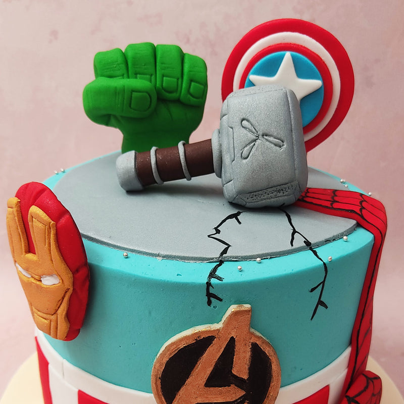 This Captain America Shield cake is adorned with various elements representing beloved Avengers characters. 