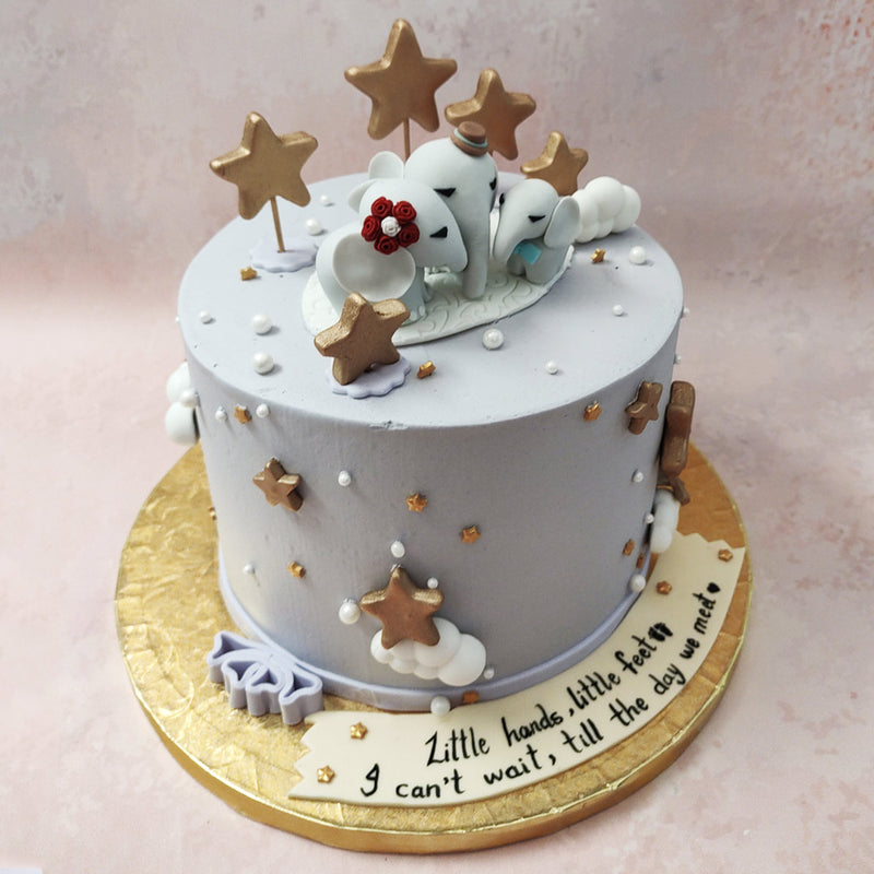 Encouraging your little one to dream and wonder, this  elephant and stars cake has a storybook and nursery theme running throughout the design, both accented and brought to life by the gold colours and centred around the three, miniature elephants on top.