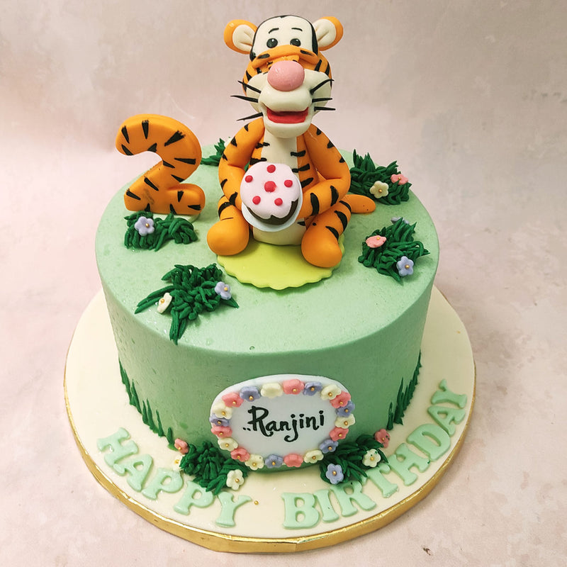 The real star of this Tigger birthday cake for kids is none other than Tigger himself! Standing proudly atop the cake, Tigger holds a strawberry frosted cake, ready to celebrate with your little one. 