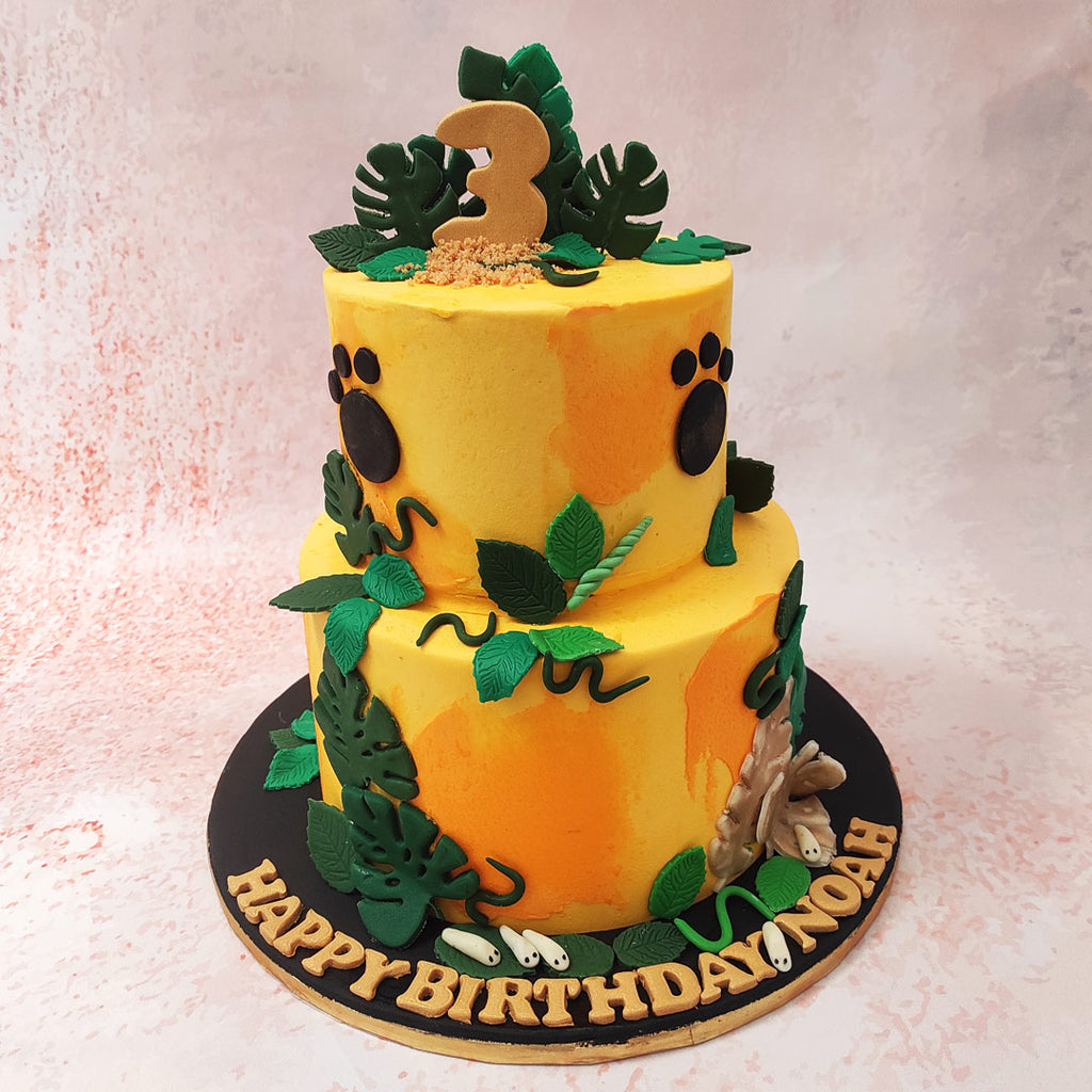 And atop this Orange and Green Cake, bold black paw prints serve as a reminder of the wild creatures that roam these lush jungles.