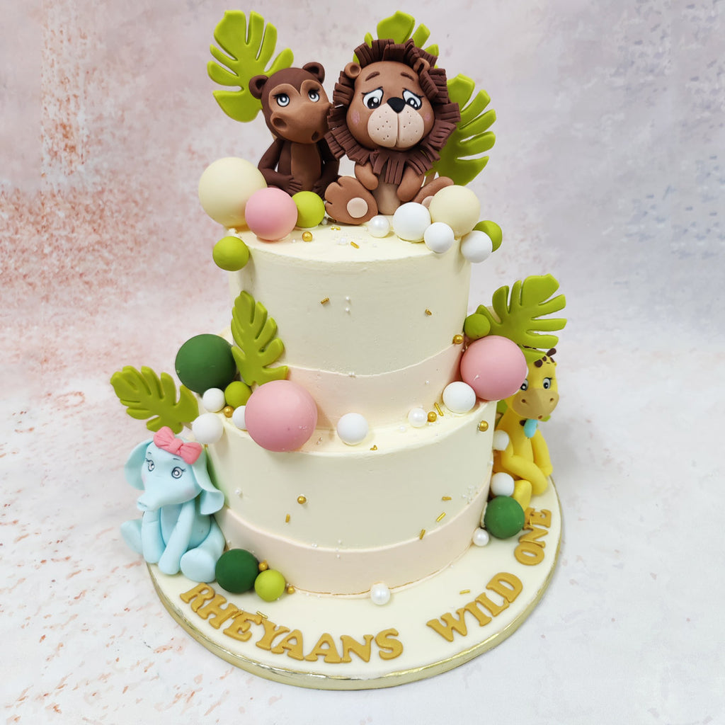 This Tropical Theme Cake With Balloons brings the magic of a whimsical safari adventure to life with its charming cast of woodland characters perched atop a pristine ivory creation. 