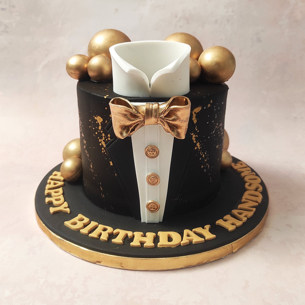 The black base of this Tuxedo Cake, adorned with delicate gold paint, sets the stage for a celebration fit for royalty.