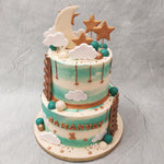 Amidst the fluffy white clouds, green, white and gold baubles and gold stars, spot the large, luminous crescent moon standing tall at the top of this birthday cake for kids. 