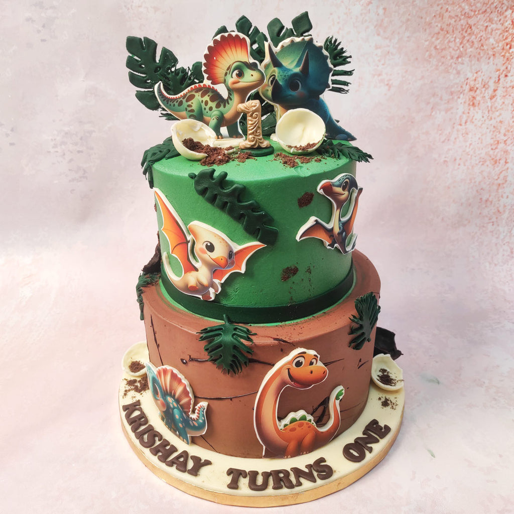 At the base of this Two Tier Dino Cake, a rugged terrain in rich brown hues sets the stage for the adventure ahead. 