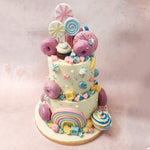 A carnival of colourful spiral lollipops crowns the top of this Dessert Theme Cake, with a rainbow at the bottom, bringing to life the sugary dreams of every dessert enthusiast!