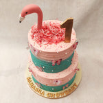 Embellishing this Flamingo head Cake are edible pearls and butterflies, which add an extra layer of charm and whimsy. 