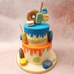  Ornamenting the entirety of this two tier ice cream theme cake are a plethora of desserts from popsicles to lollipops, from macarons to donuts, turning this birthday cake for kids into a vibrant dessert platter.