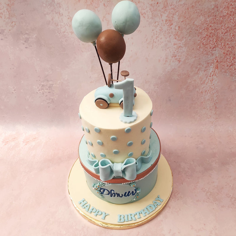 A charming bow elegantly ties the tiers together, adding a touch of elegance to this delightful confection while the balloon cake topper sprinkles in the whimsy.