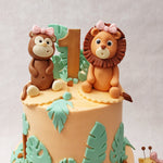 But what truly sets this elephant and giraffe cake apart are the adorable miniature figurines that adorn both tiers. 