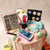 As your eyes wander over the surface of this Vanity Cake, you are greeted by an array of meticulously crafted, edible adornments that are the quintessence of a teenage girl’s sanctuary from make-up to books to a phone to headphones to a paint-palette