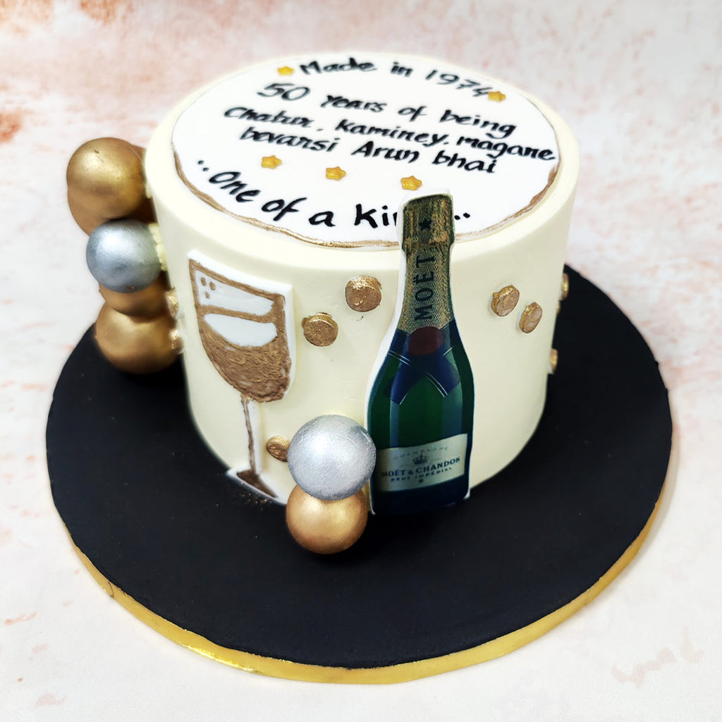 The artistry showcases exceptional skill, particularly in the hand-painted wine glass illustration that graces this Vintage Champagne Cake’s cream canvas.