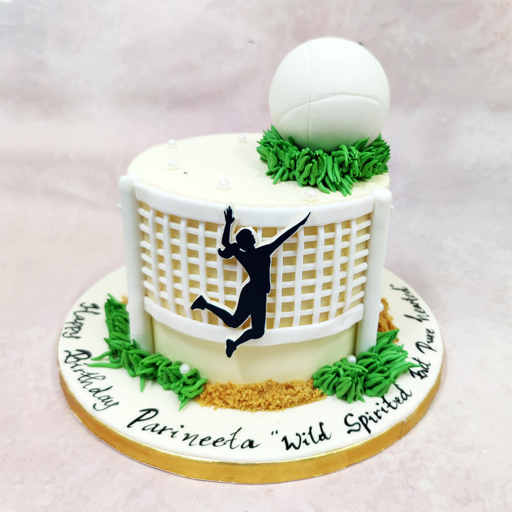 The detailing across this Birthday Cake For Girls is fresh and focused—piped turf, crushed biscuit “sand,” and pearl-like accents that add a refined touch while still keeping the theme playful. The curved net, slightly raised from the surface, creates depth and shadow, like a freeze-frame of her favourite moment in the game.
