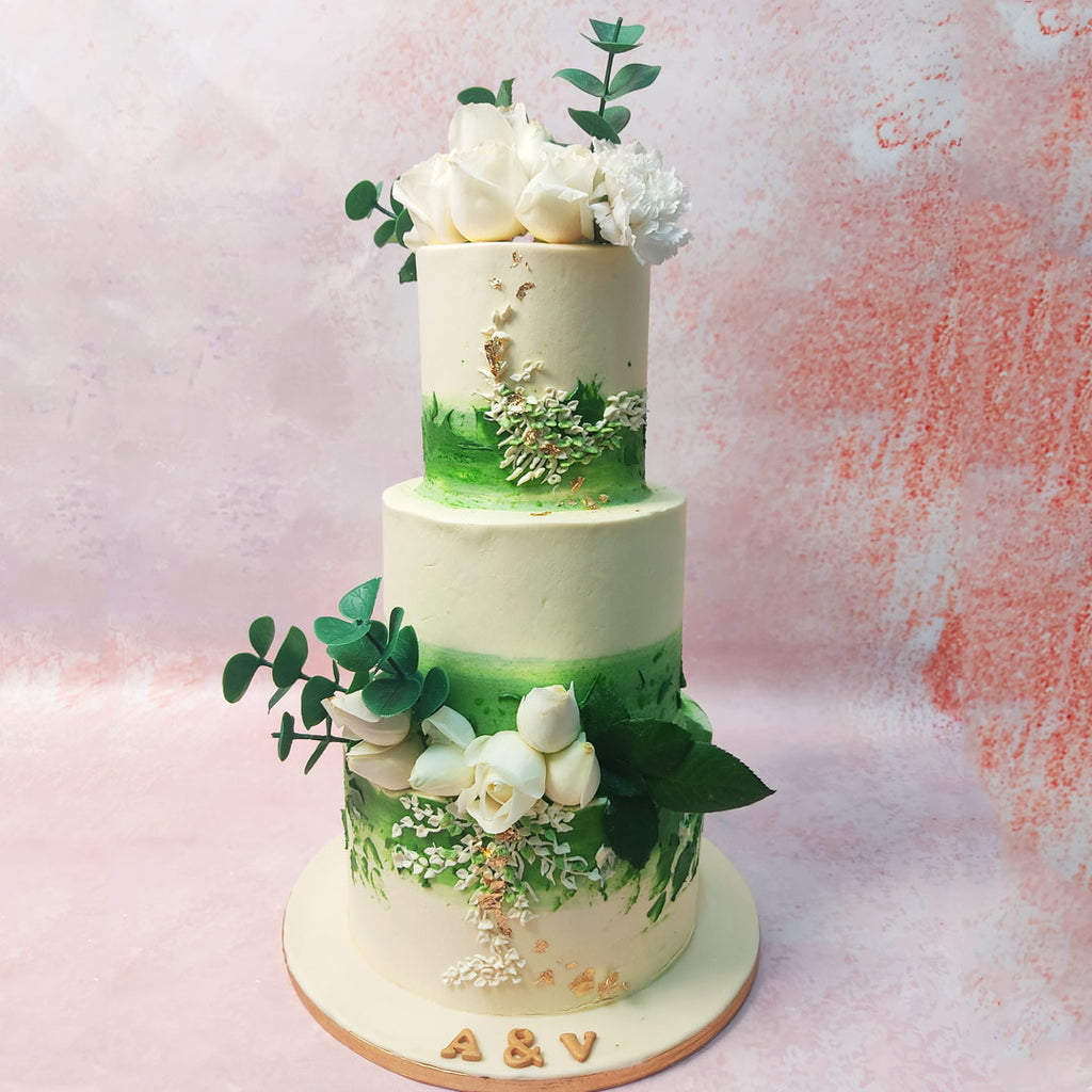 This White Rose Cake features a mesmerising green to white ombre as the backdrop of both tiers. 