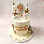 Delicate green, white, and gold baubles cascade gracefully down this White and Gold Baptism Cake, alongside angel wings.