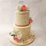 The showstopper of this two tier white and gold cake with flowers are the floral cake toppers. Fresh pink and white roses to symbolise all the sentiments of a life and love shared together. 