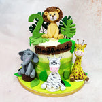 This Wild Animals Cake is a jungle jamboree in fondant, bursting with personality and charm for your little adventurer’s big day. 