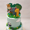 This whimsical wildlife cake is adorned with sky blue bases, beautifully ornamented with fluffy white clouds and vibrant plant life at the bottom, creating a captivating scene that will capture the imagination of children.