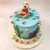 This Birthday Cake For Kids’ intricate details include a beautifully detailed picket fence, vibrant trees, and enchanting mushrooms, creating a magical scene straight from the pages of A.A. Milne's timeless tales. 